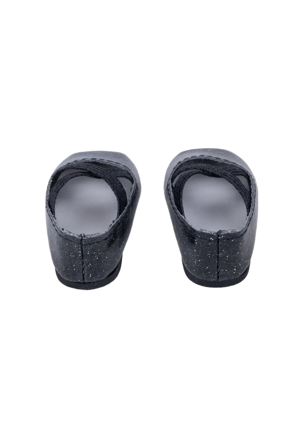 Pair of black doll shoes on a white background