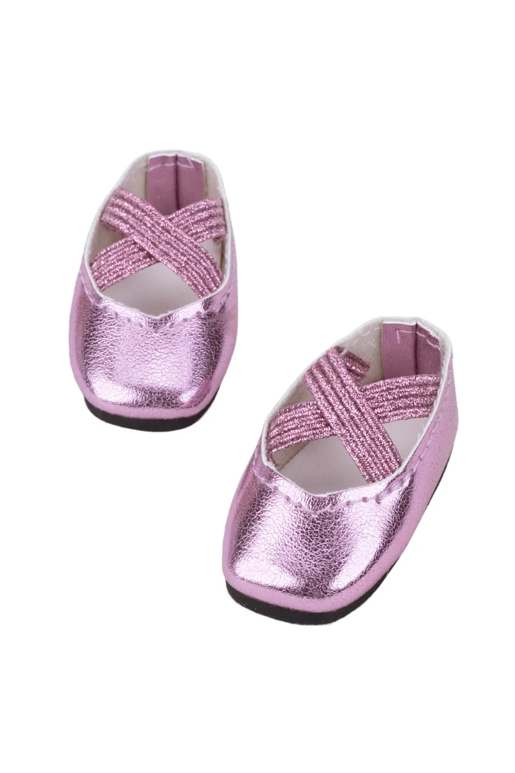 Pair of pink metallic doll shoes on a white background