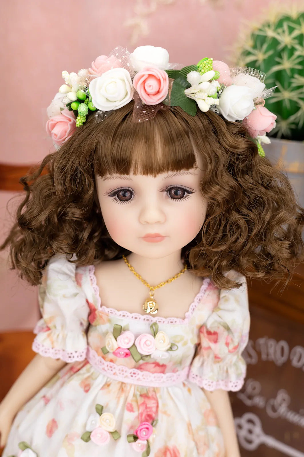 Doll with floral headband and dress in a decorative setting
