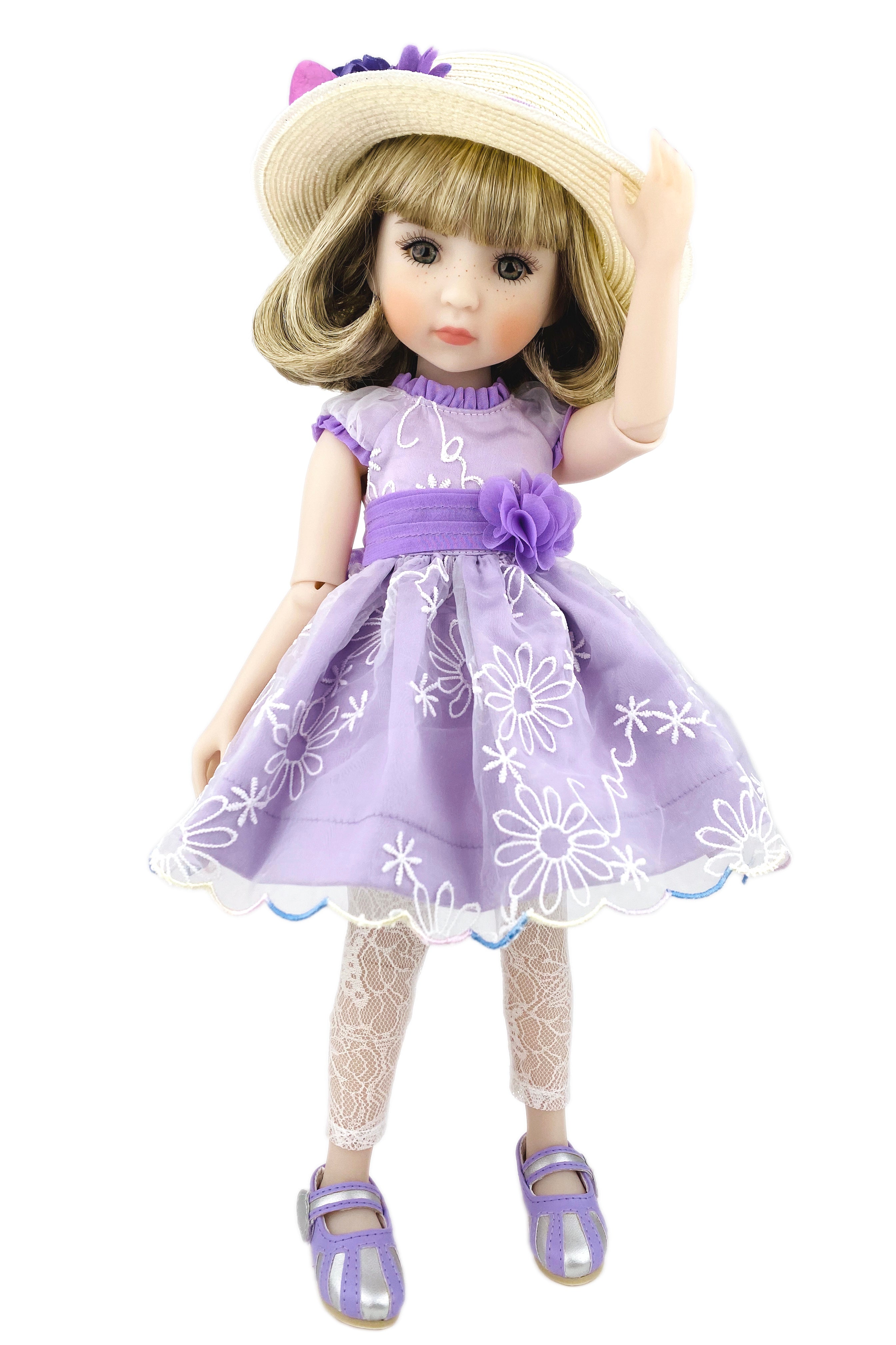 Doll wearing a purple dress with floral patterns and a matching hat on a white background