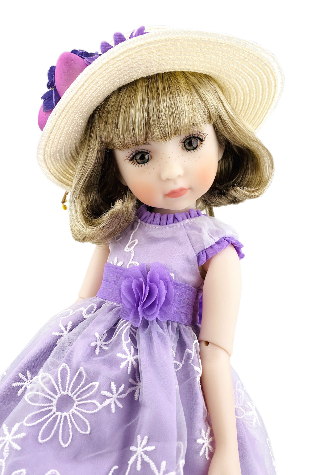 Doll wearing a purple dress with floral details and a matching hat on a white background