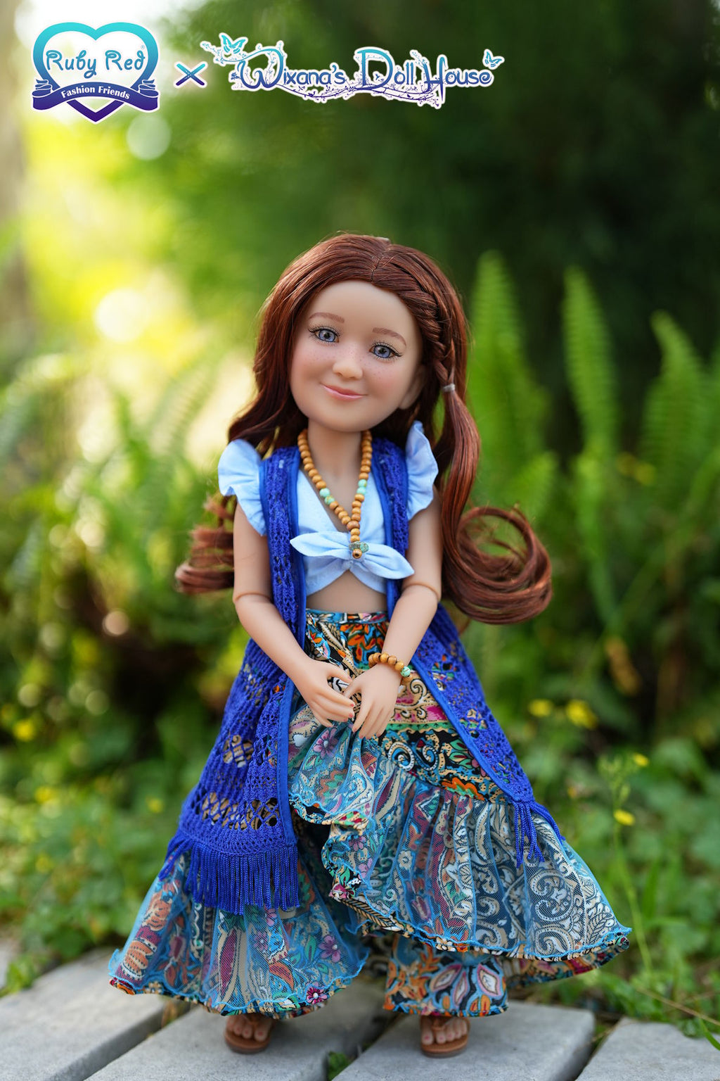 Doll with a colorful outfit standing outdoors on a wooden surface with greenery in the background.