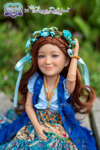 Doll with floral headpiece and colorful outfit in a natural setting
