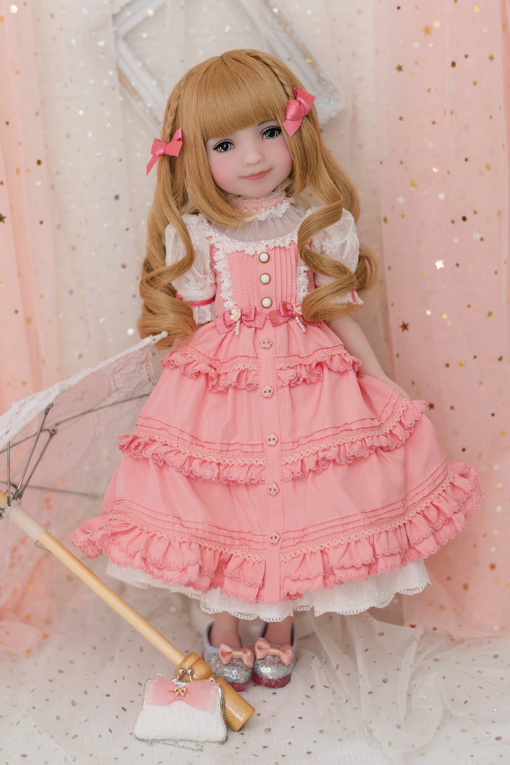 Doll in a pink dress with ruffles against a pink polka dot background