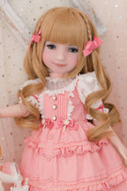 Doll with blonde hair styled in pigtails, wearing a pink dress with white lace details.