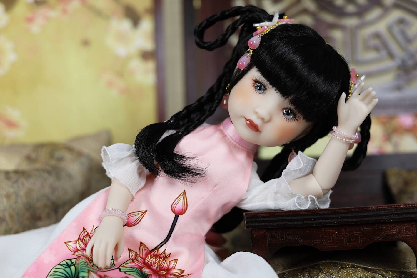 Doll in a traditional outfit with floral design on a decorative background