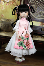 Doll wearing a traditional outfit with floral design in a decorative setting