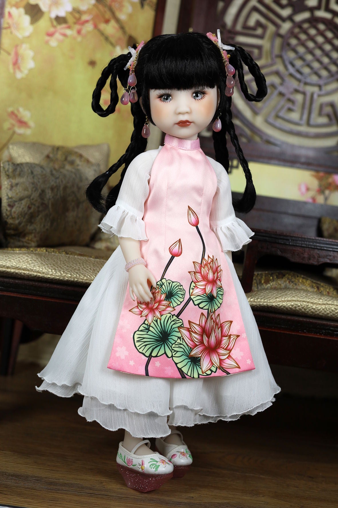Doll wearing a traditional outfit with floral design in a decorative setting