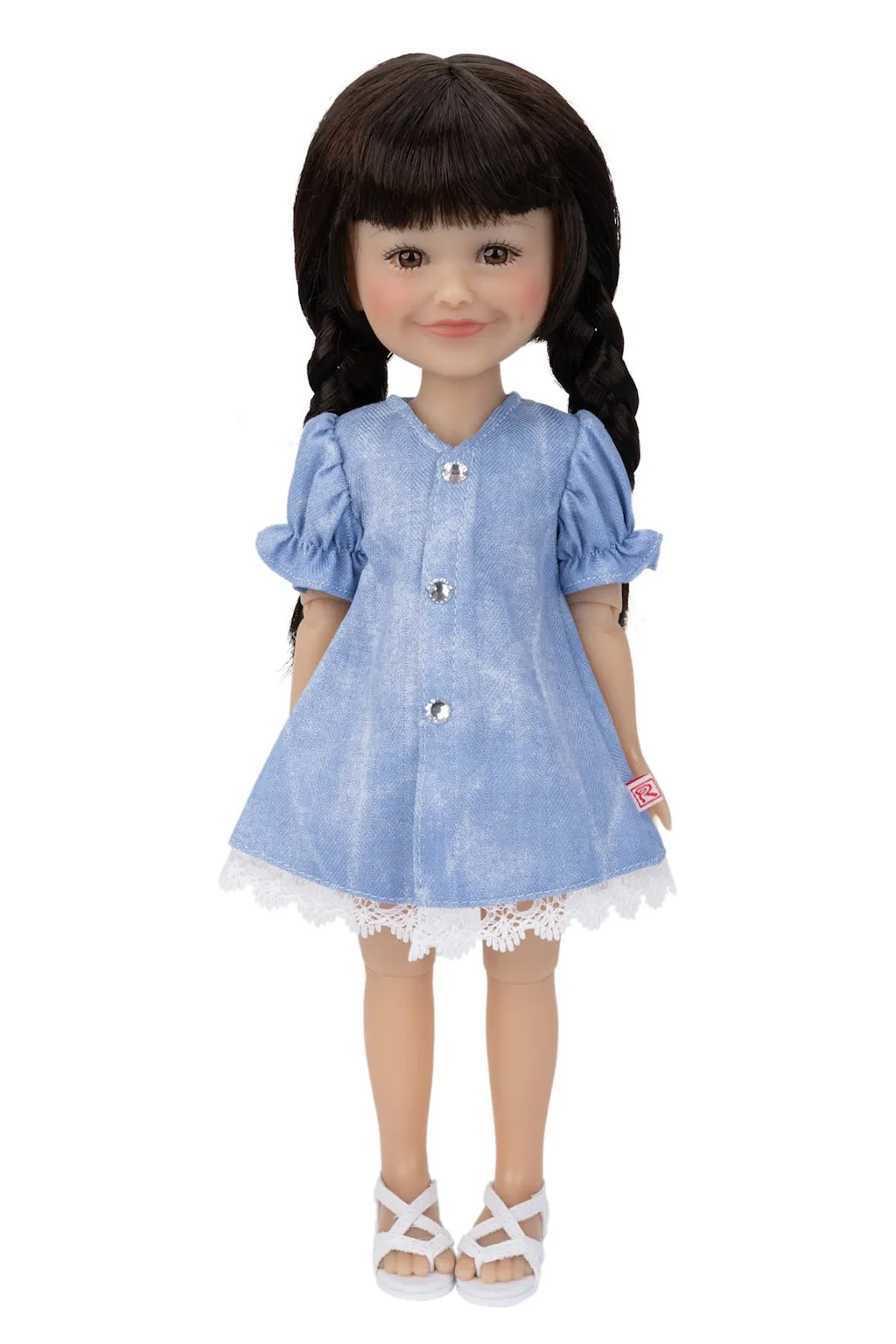 Doll wearing a blue dress with white buttons on a white background