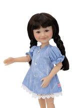 Doll wearing a blue dress with lace trim on a white background