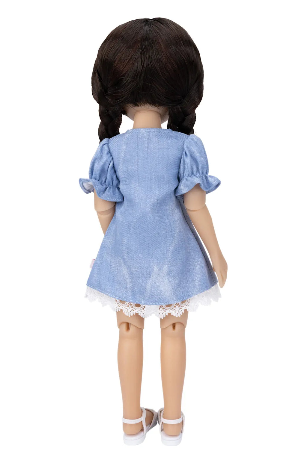 Doll wearing a blue dress with lace trim on a white background