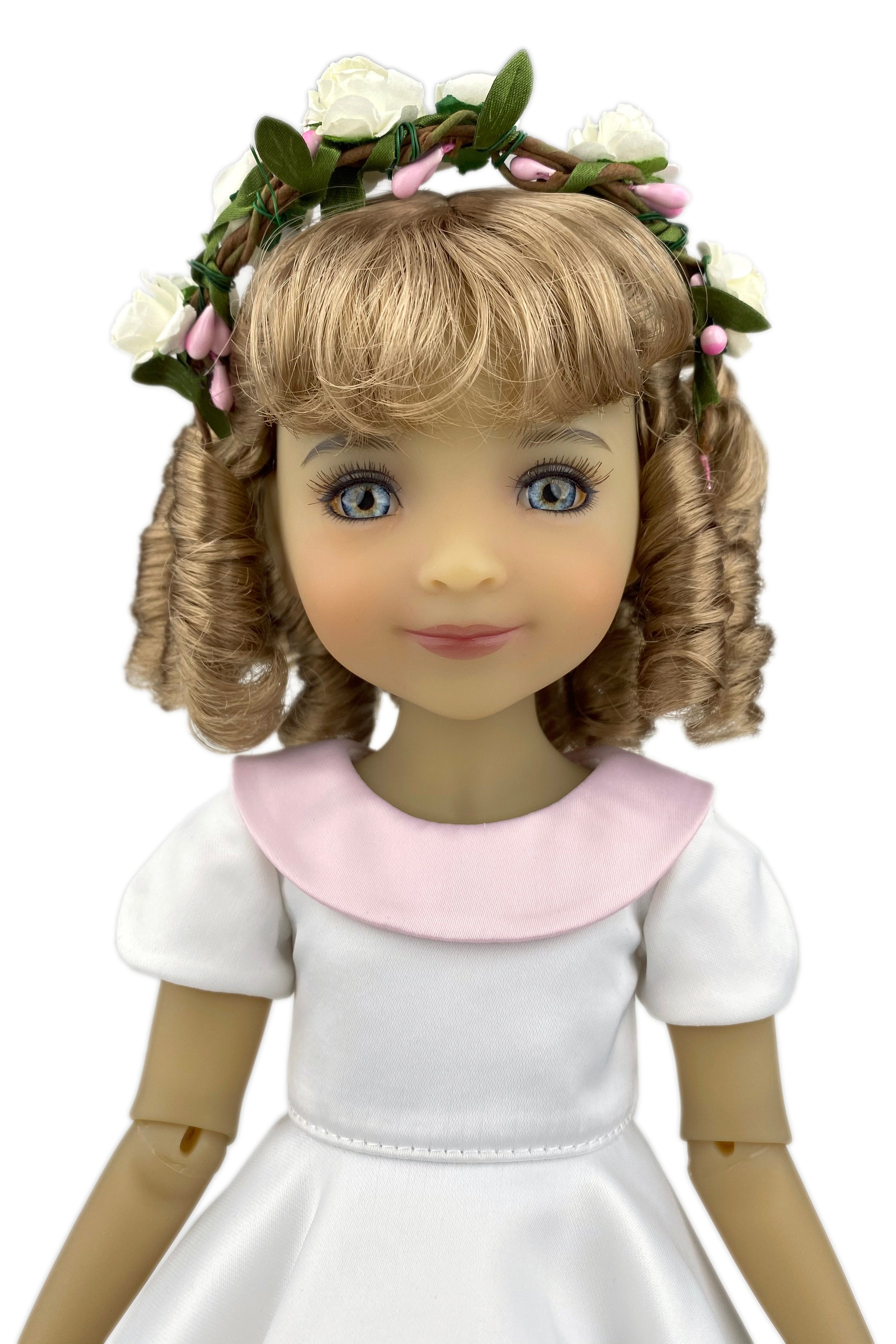 Doll with floral crown and white dress on a white background