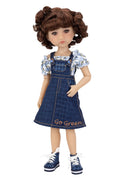Doll wearing a denim dress with floral top on a white background