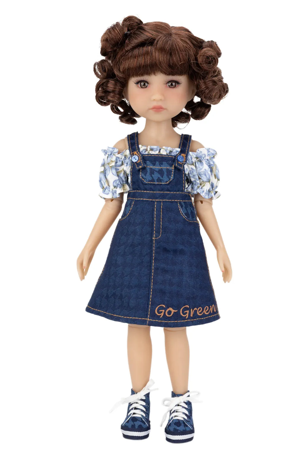 Doll wearing a denim dress with floral top on a white background