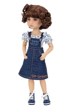 Doll wearing a denim dress with 'Go Green' text on a white background