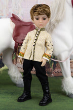 Doll in equestrian attire standing next to a horse with a saddle.