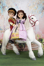 Two dolls in historical attire sitting on a white horse with a floral background