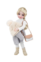 Doll wearing a winter outfit with a beige bag and white sweater on a white background