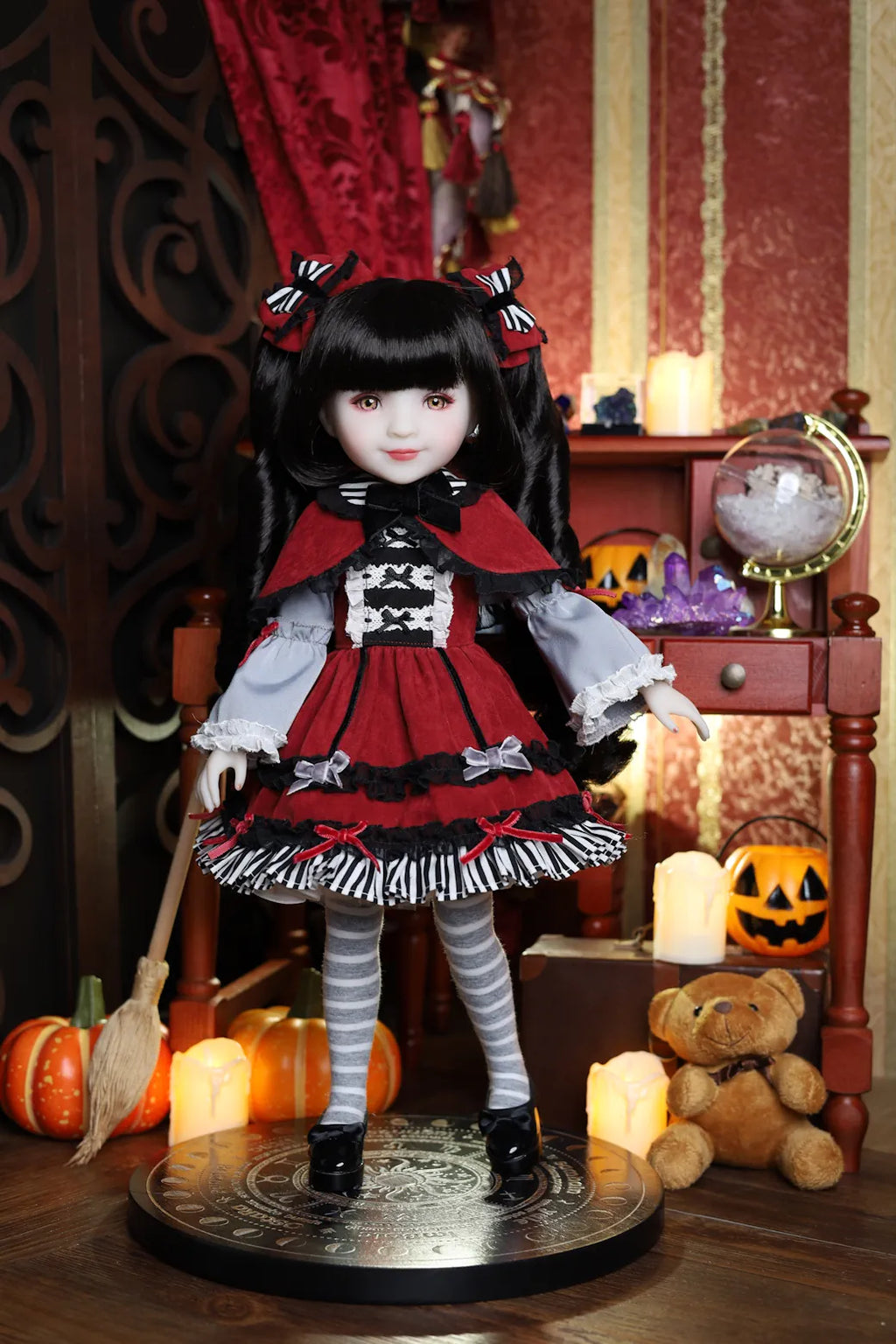 Doll in a Halloween-themed setting with pumpkins and candles