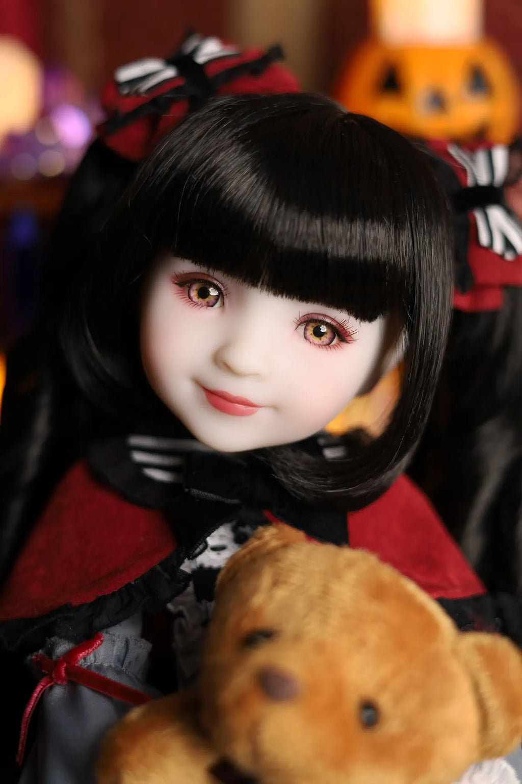 Child wearing a Halloween costume with a teddy bear