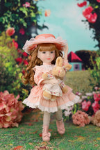 Doll in a pink dress and hat holding a  rabbit plush toy in a garden setting