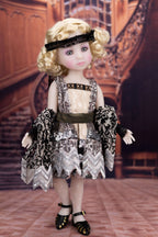 Doll in a vintage outfit standing in an elegant interior setting