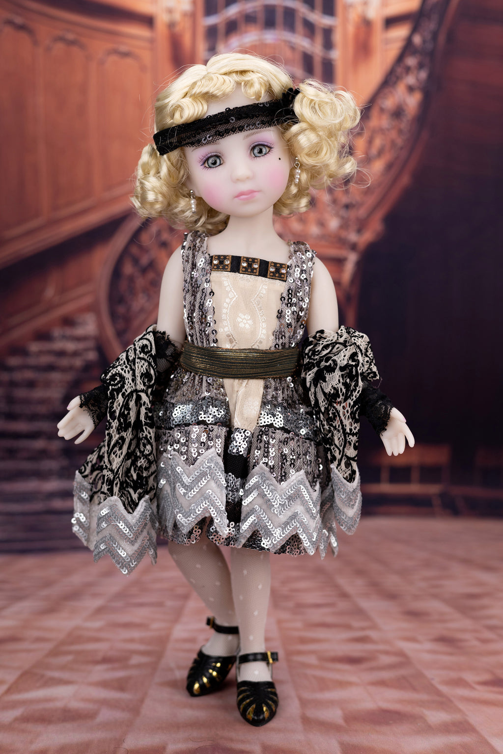 Doll with vintage-style dress and accessories in a decorative interior setting