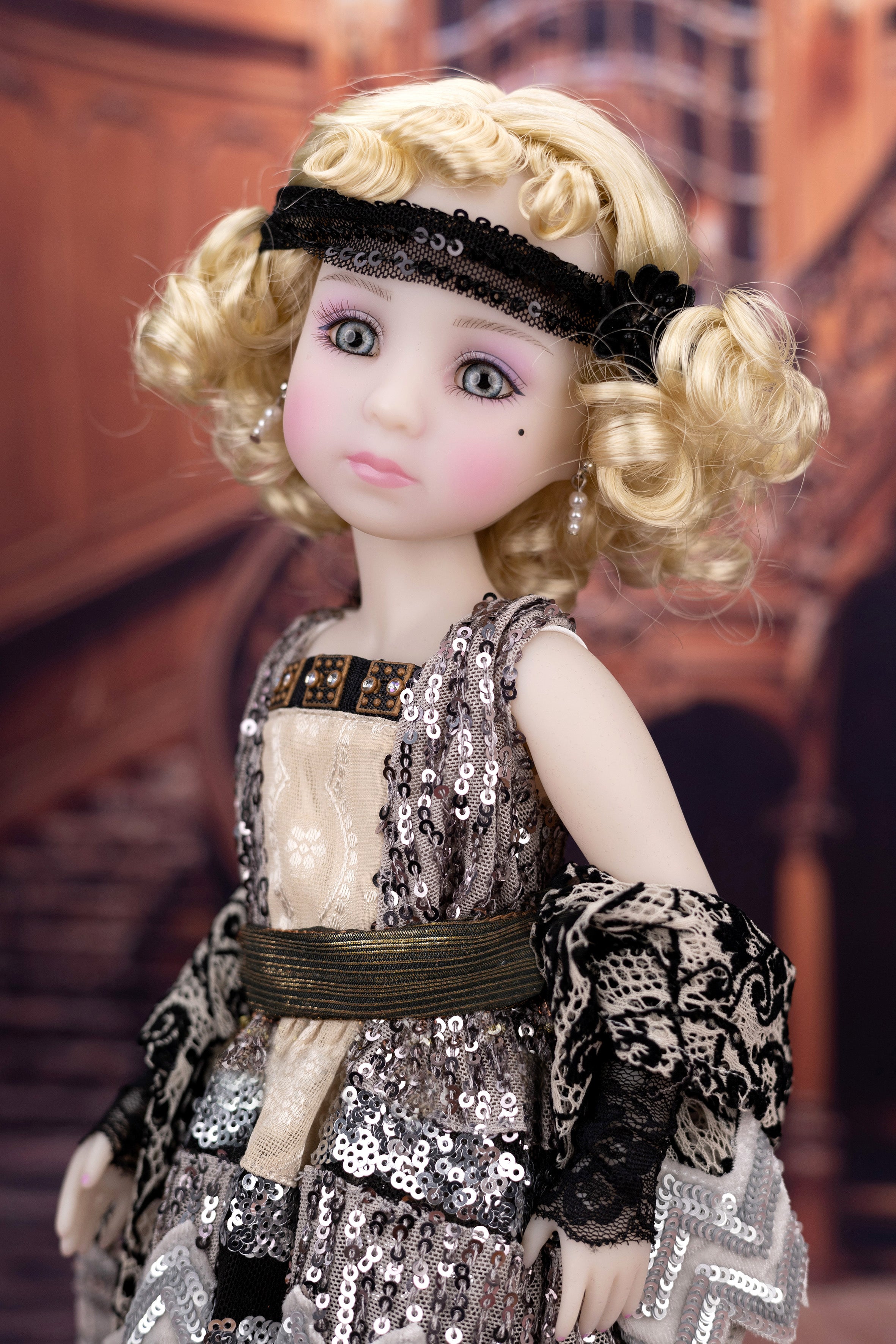 Doll with blonde hair and a detailed outfit in a decorative setting