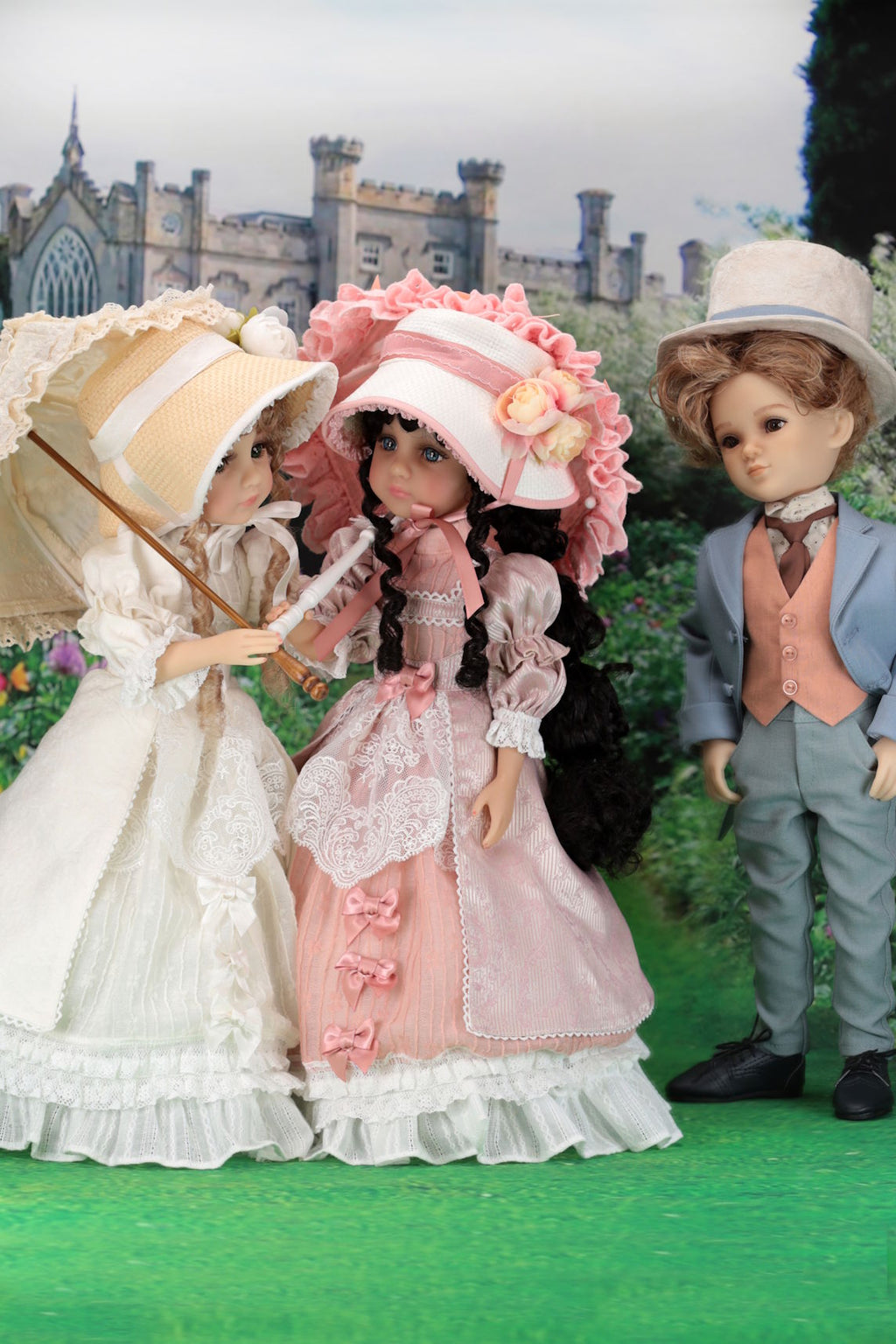 Three dolls in period costumes standing outdoors with a castle-like structure in the background.