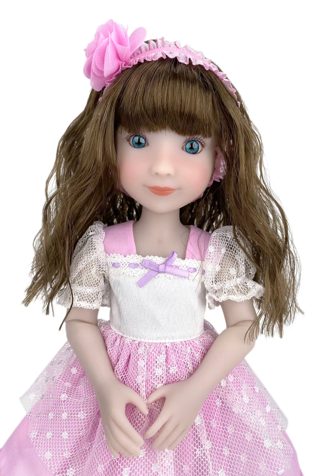 Doll with brown hair and a pink dress on a white background