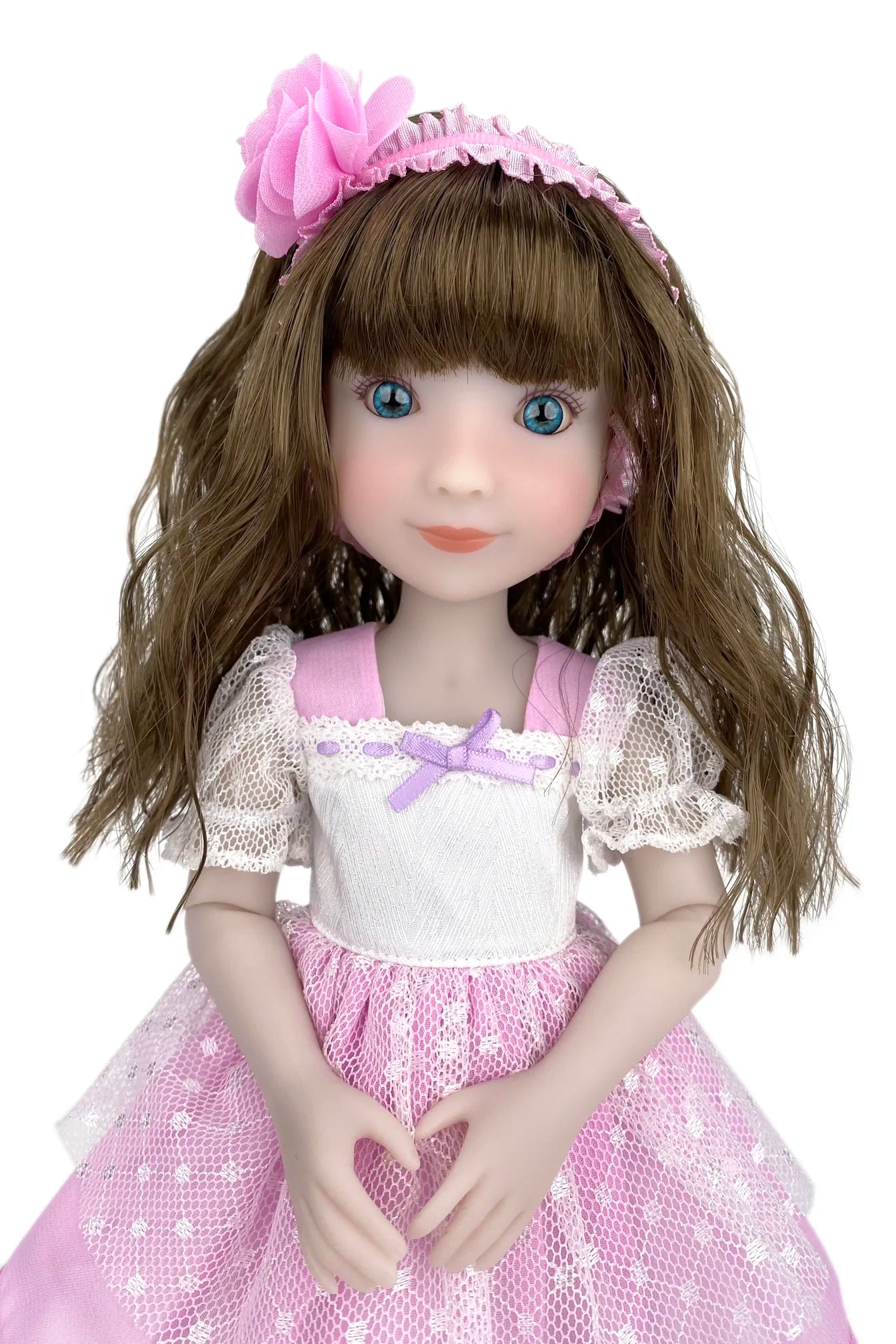 Doll with brown hair and a pink dress on a white background