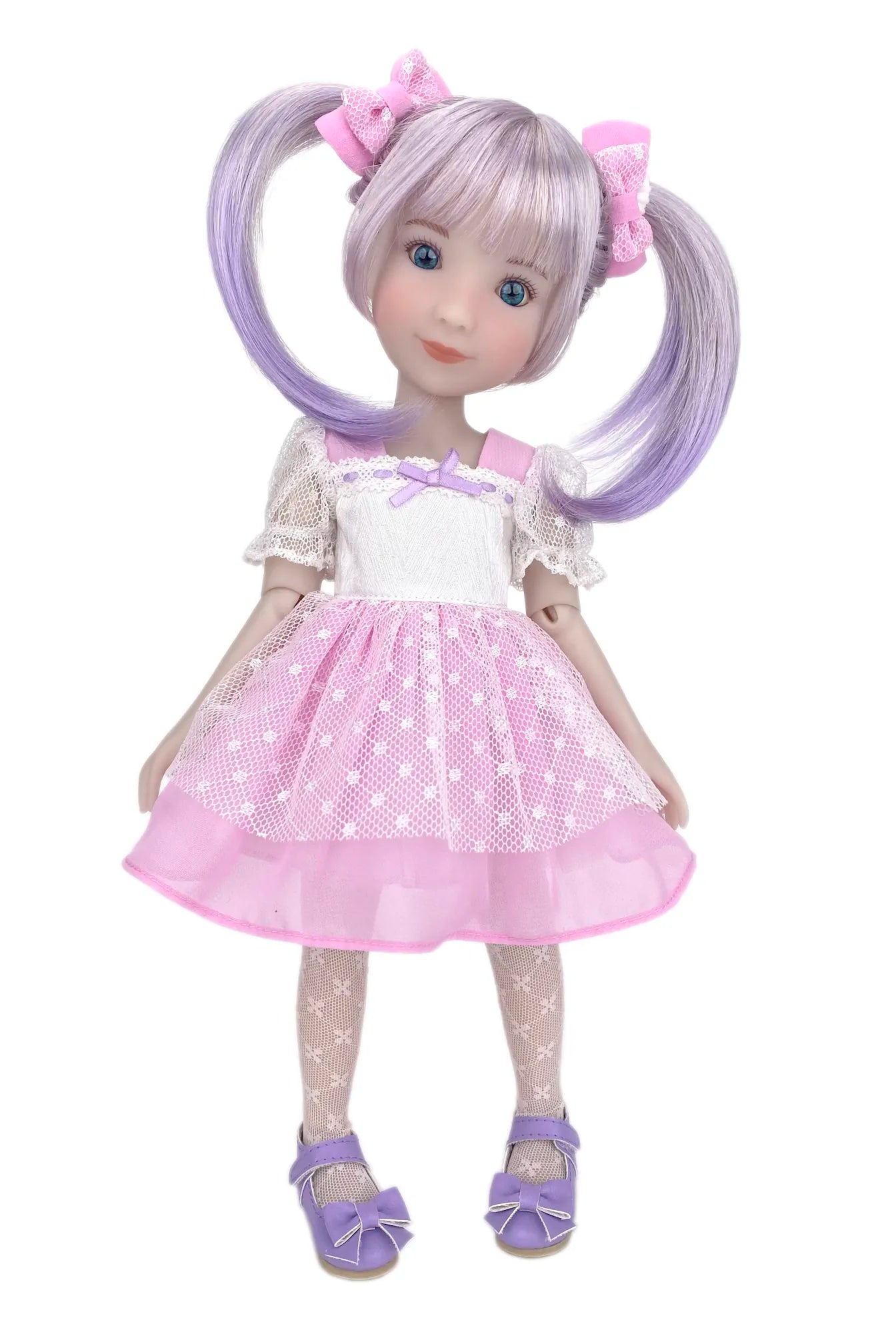 Doll with purple hair styled in pigtails, wearing a white dress with pink polka dots and matching shoes on a white background.