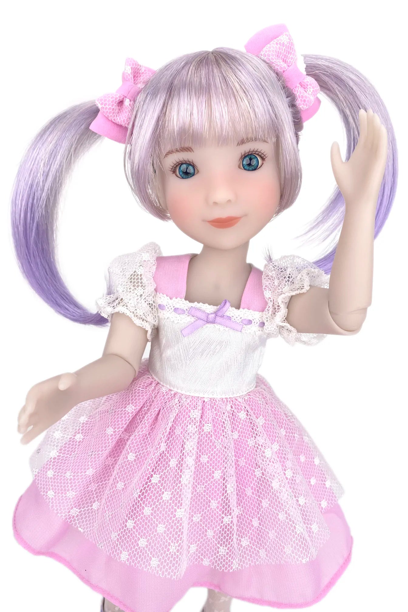 Doll with pink hair and a pink dress on a white background