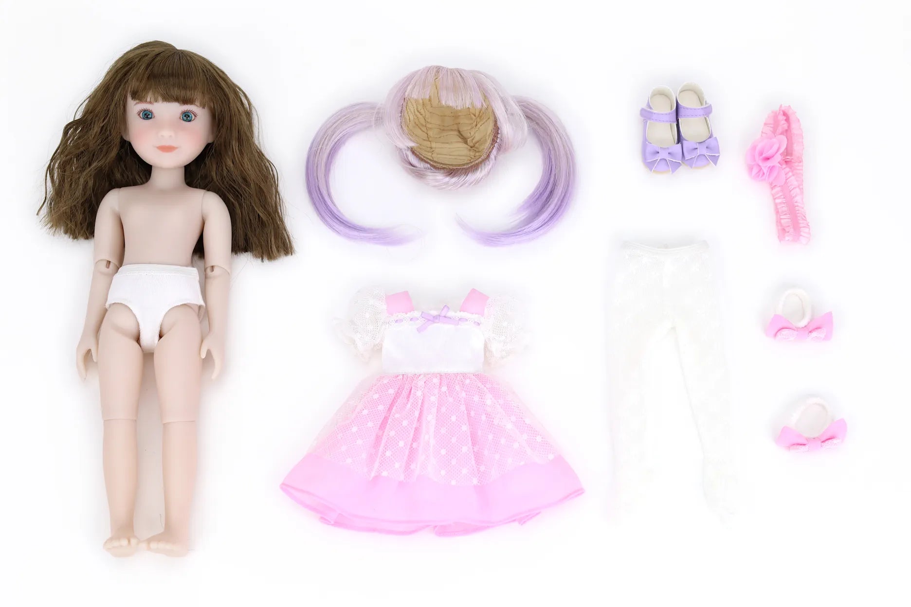 Doll with accessories including a pink dress, hair extensions, and shoes on a white background