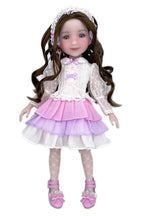 Doll with long brown hair wearing a white and purple outfit on a white background