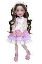 Doll with long brown hair wearing a white lace top, pink skirt, and matching shoes on a white background
