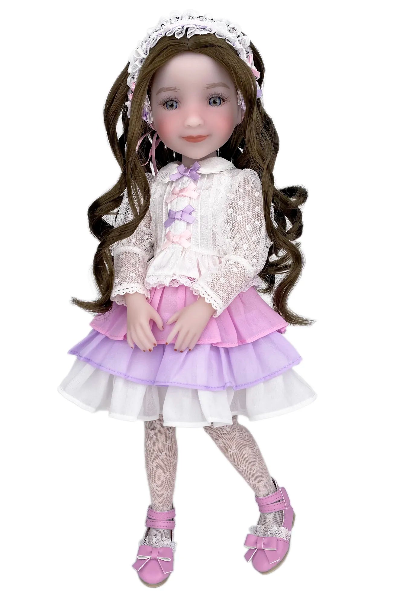 Doll with long brown hair wearing a white lace top, pink skirt, and matching shoes on a white background