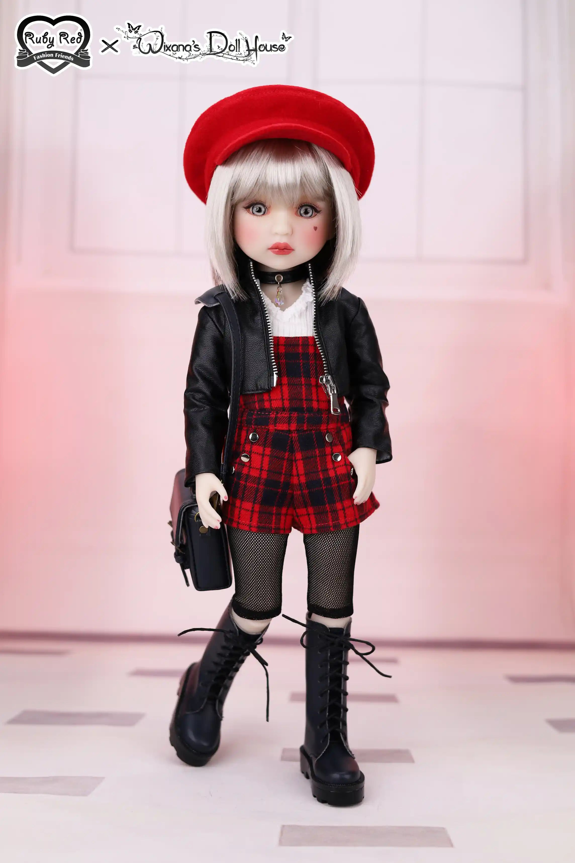 Doll wearing a red beret, black jacket, plaid skirt, and black boots on a white background.