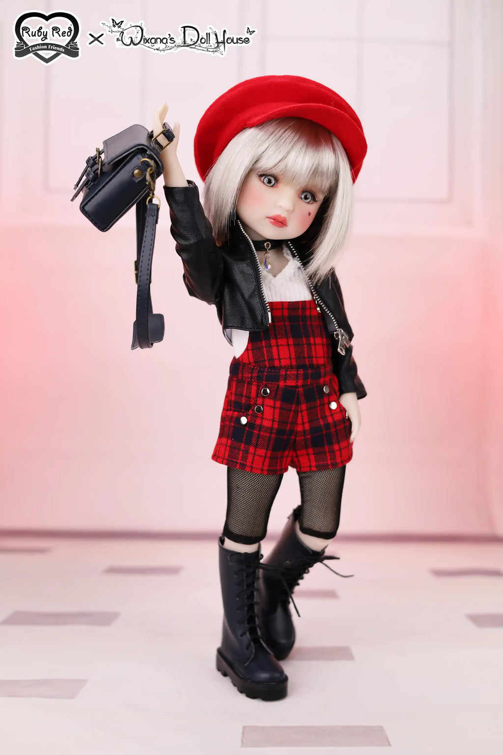 Doll wearing a red beret, black jacket, plaid skirt, and black boots on a light background.