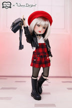 Doll wearing a red beret, black jacket, plaid skirt, and black boots on a light background.