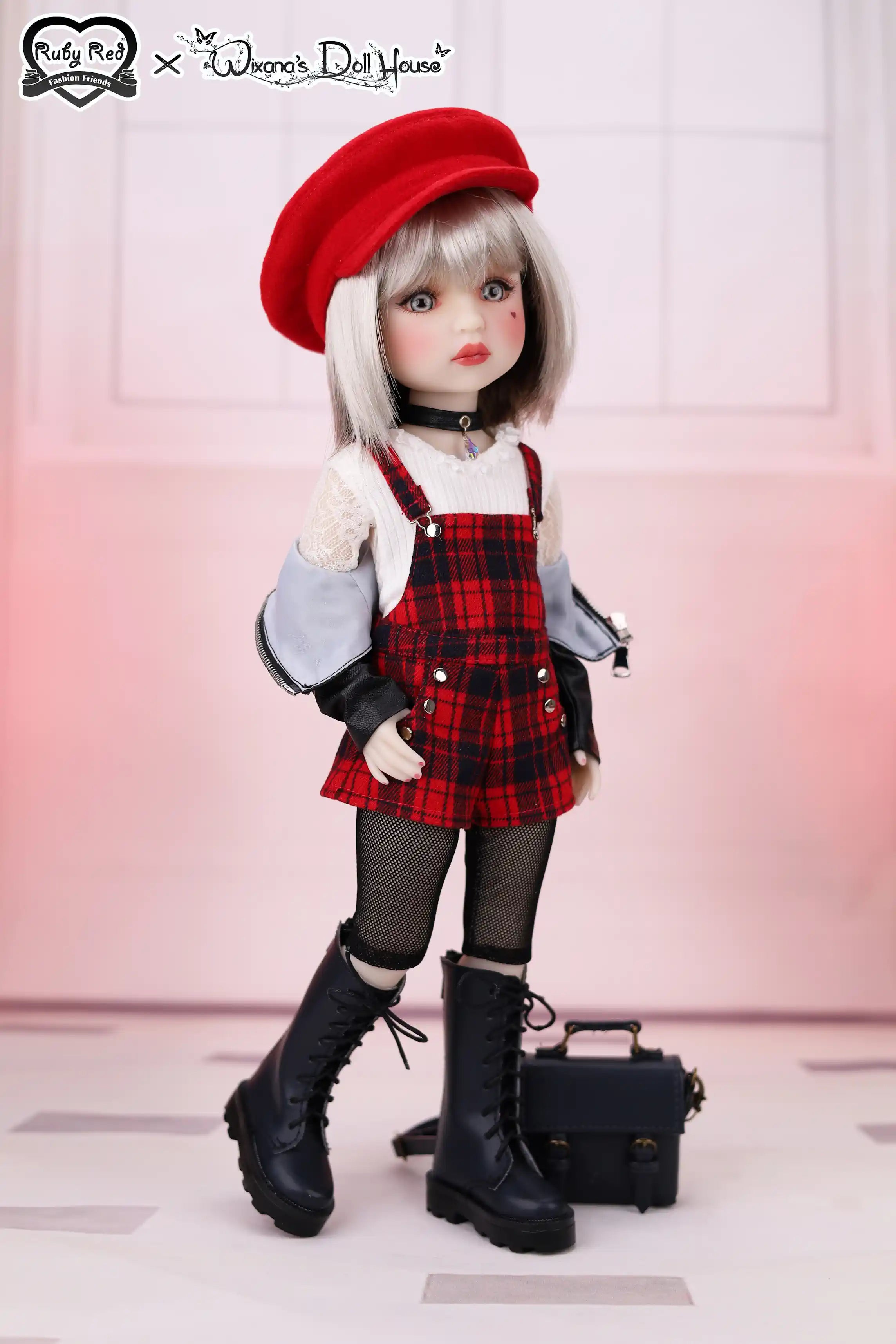 Doll wearing a red beret, plaid dress, and black boots with a small handbag.