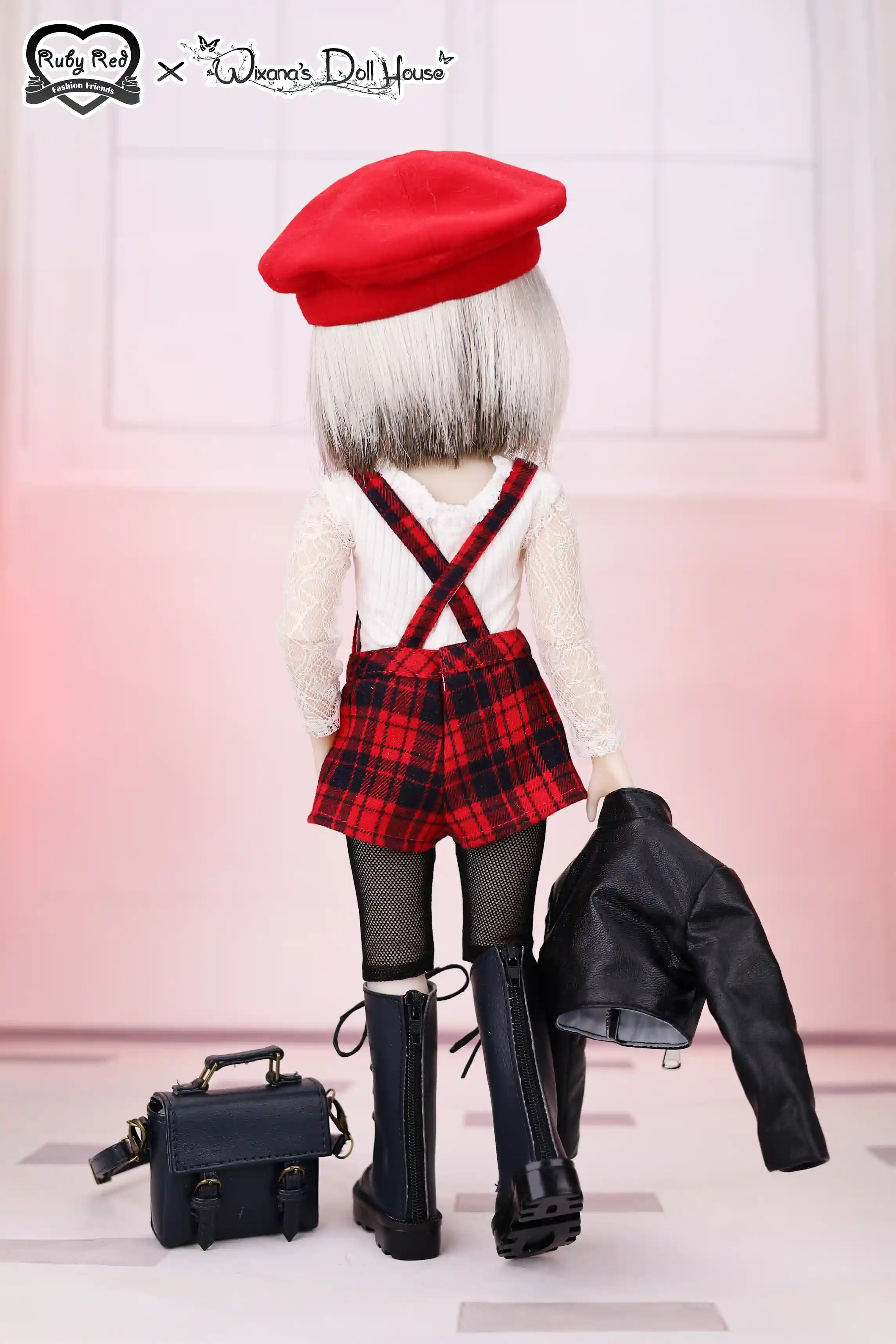 Doll wearing a red beret, plaid outfit, and black boots with a pink gradient background.
