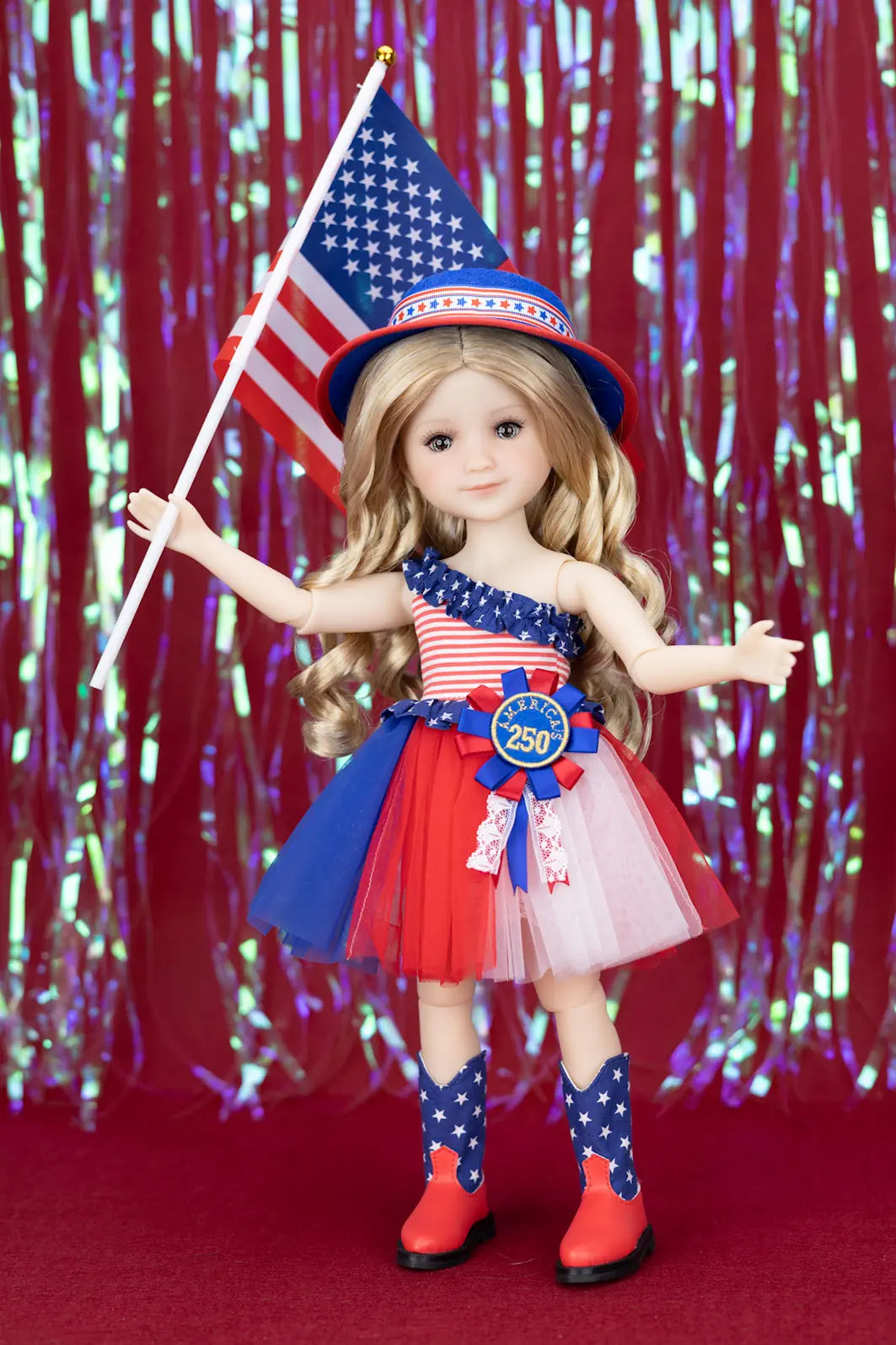 Doll in patriotic outfit with American flag and 'Betsy Ross' hat against a red and blue festive background