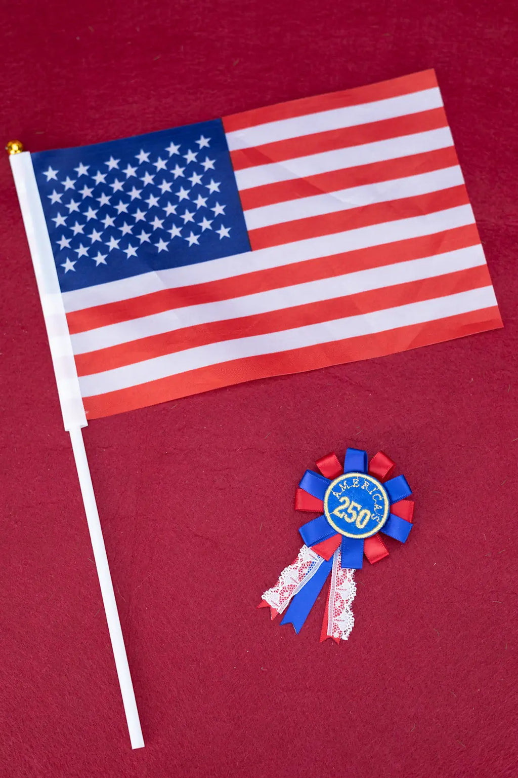 American flag and a decorative ribbon on a red background