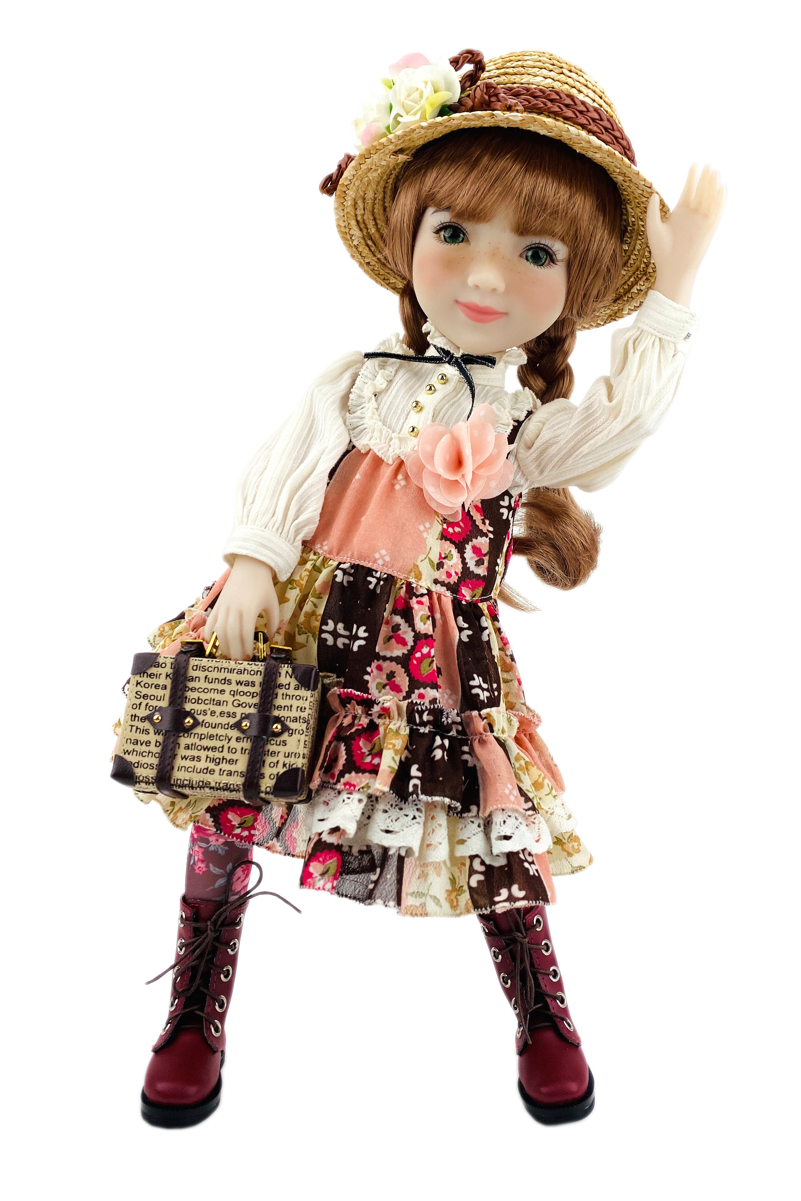Doll in a vintage outfit with a hat and floral dress on a white background