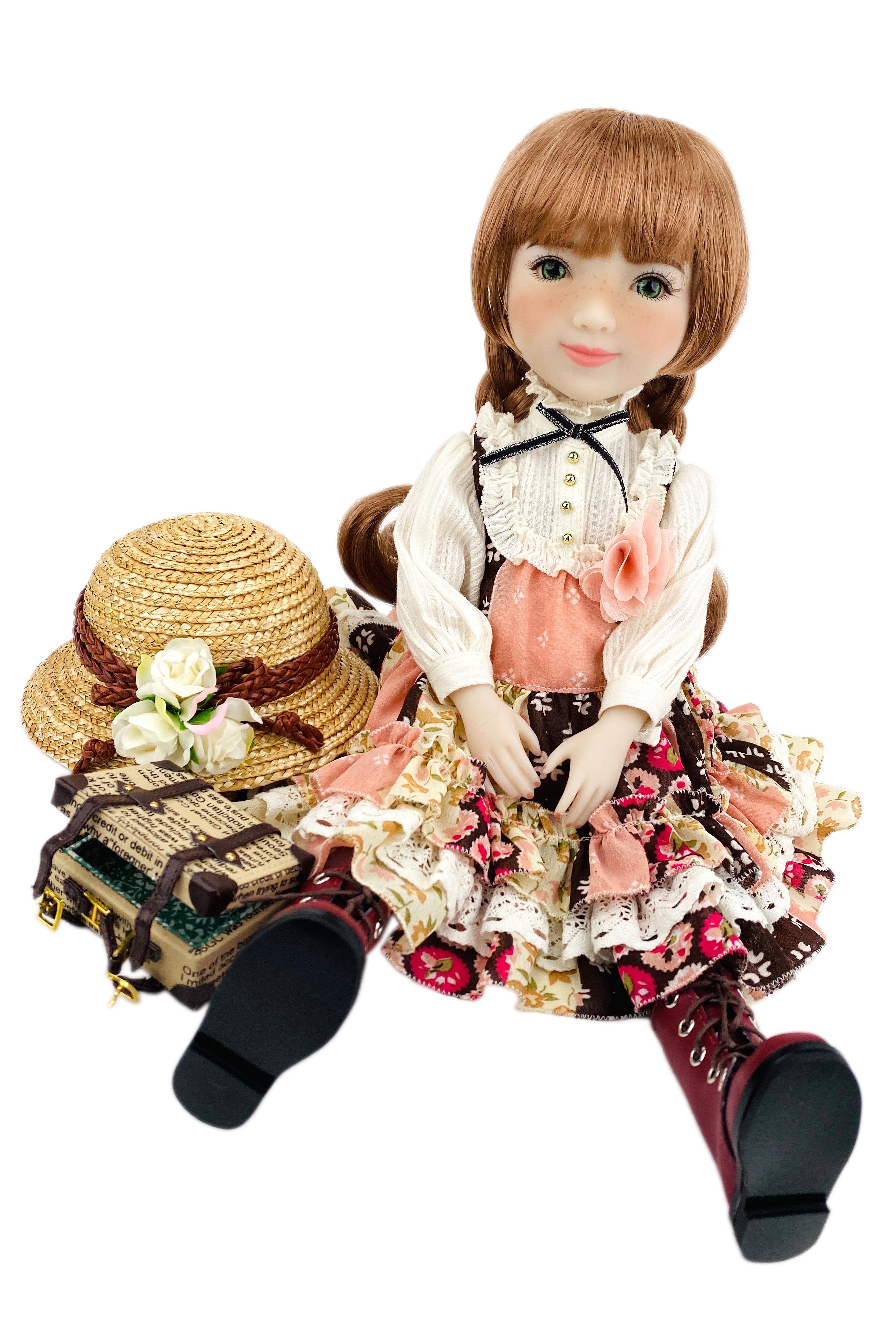 Vintage-style doll with a hat and book on a white background