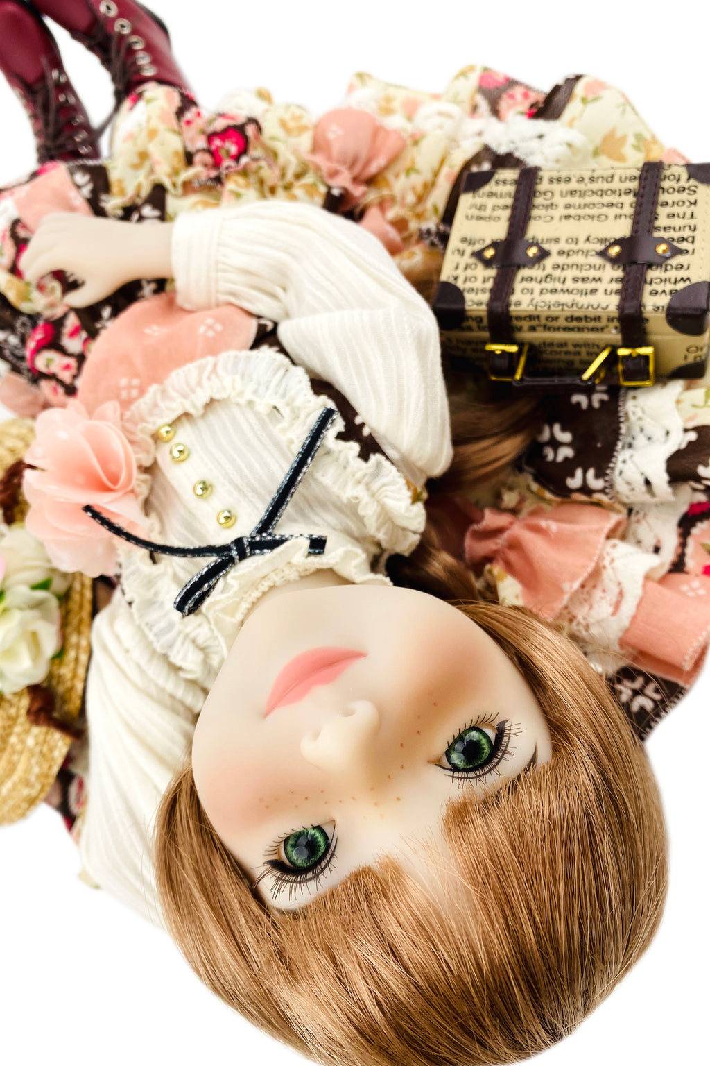 Detailed doll with intricate clothing and accessories on a white background