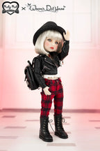 Doll in a stylish outfit with a black jacket, plaid pants, and black boots on a light background.