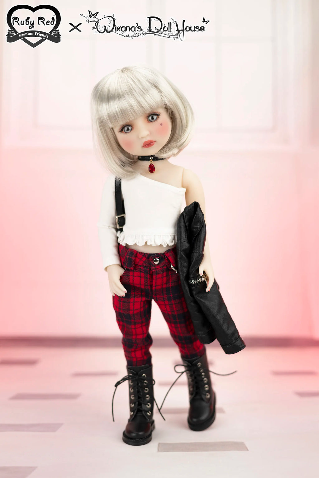 Doll with white hair and plaid pants standing against a light pink background