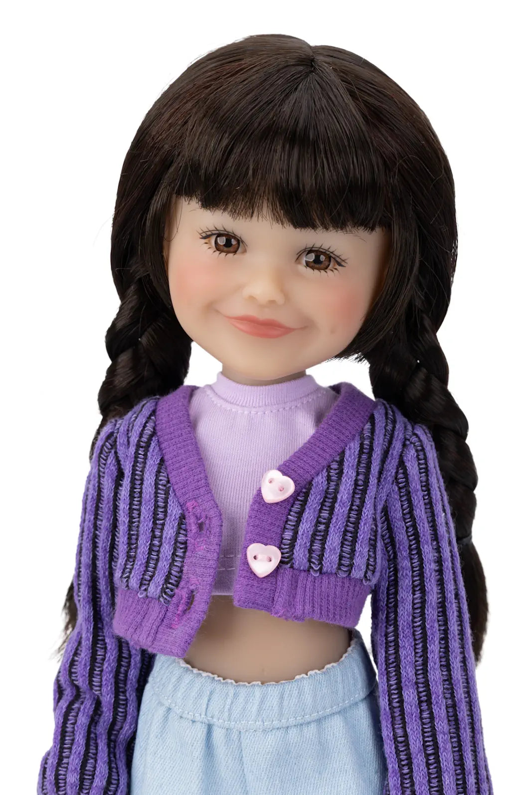 Doll wearing a purple cardigan with heart buttons on a white background